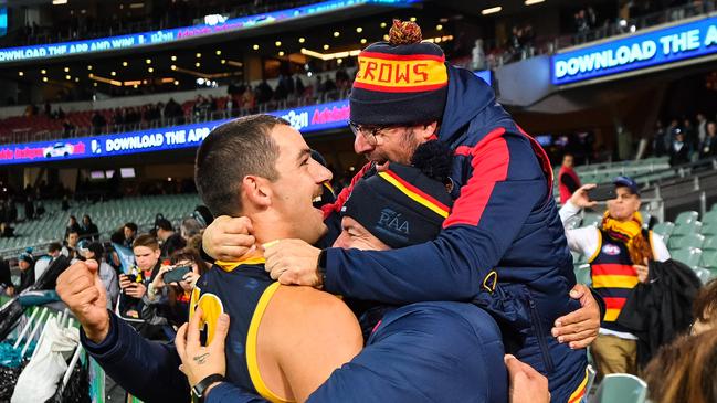 Adelaide forward Taylor Walker embraces fans after a win last year. Picture: Daniel Kalisz/Getty Images