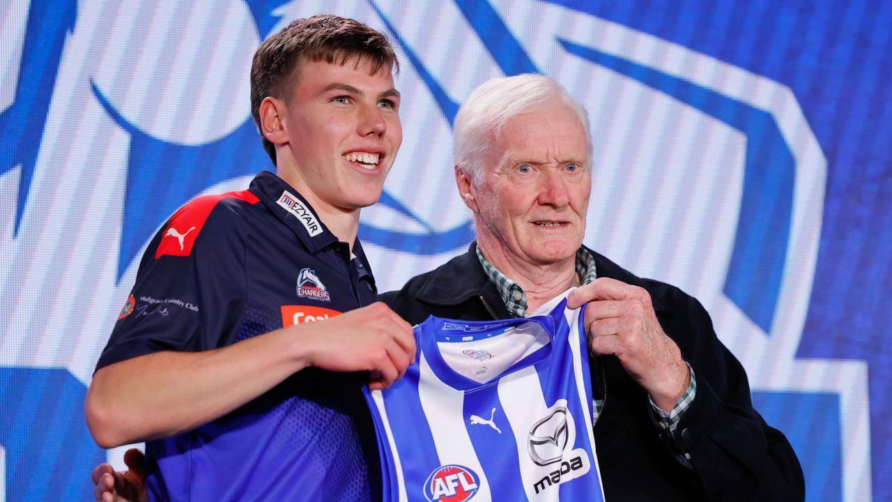 Finn O’Sullivan gets his jumper from Keith Greig after being drafted.