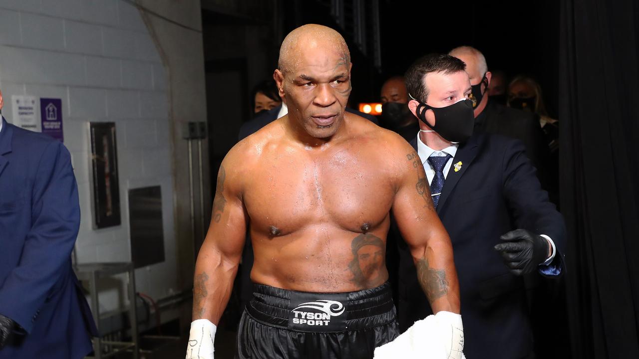 Mike Tyson exits the ring after his draw with Roy Jones Jr.