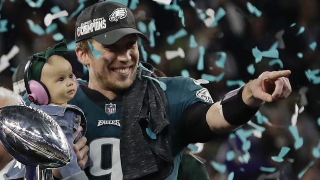 Philadelphia Eagles quarterback Nick Foles holds his daughter after winning Super Bowl 52. Picture: AP.