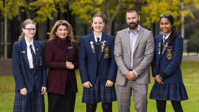 Vice school captain Christine, principal Dawn Clements, Erin, Flow Power director David Evans and school captain Imashi celebrate the school’s move.