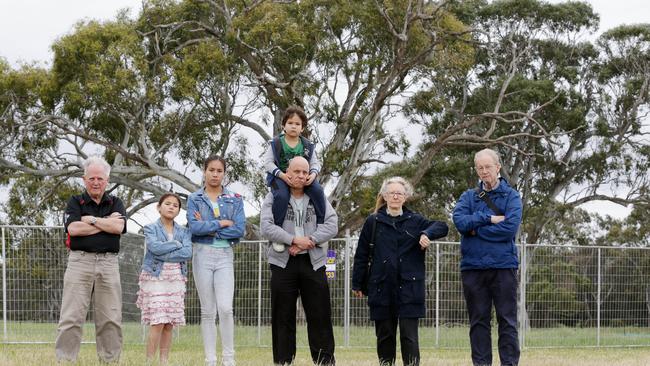 RAMF members Mike McKeon, Scott Fothergill and his children Rhys, Tia and Lyla, and more members Nina and Brian Earl, in front of two gums to be destroyed by freeway works. Picture: Norm Oorloff