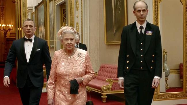 Daniel Craig escorting the Queen in a previous Bond film. (Photo by LOCOG / AFP)