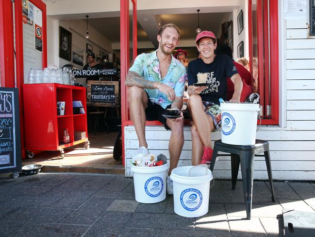 Pictured at Hemingway's cafe at Manly is cafe manager Tommy Schoeb with Surf Rider Foundation Manly member Jude Furniss. They are involved in a program that rewards customers with free coffee if they bring a bucket of rubbish from the beach.Picture: Richard Dobson