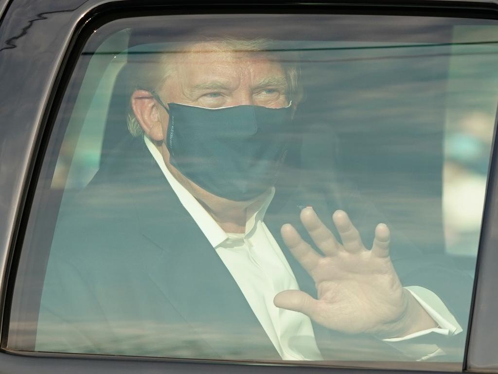 A car with US President Trump drives past supporters in a motorcade outside of Walter Reed Medical Center in Bethesda, Maryland, after he is released from hospital after a battle with COVID-19. Picture: AFP