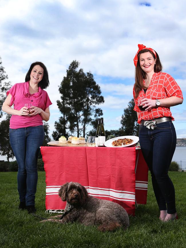 Chantel Crossman, who enjoys being able to take her dog, Max, to the Hobart Twilight Market, gets an early taste from Jaclyn Schapel, a stall holder from Domaine Simha, who will sell oysters and wine. Also on her table is fare from PavLovas and Wood Fiery Redhead Pizza. The market returns to Sandy Bay tonight for its second season. Picture: NIKKI DAVIS-JONES