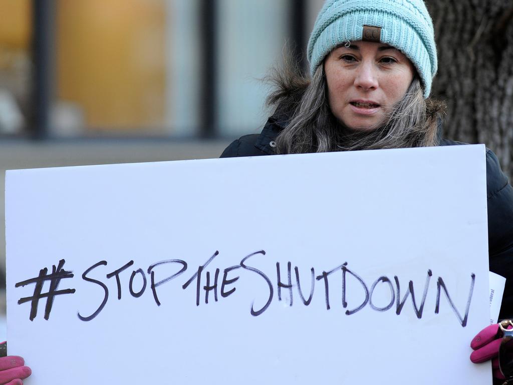 Protesters hold signs during a rally near the headquarters for the Environmental Protection Agency and Internal Revenue Service headquarters in Boston. Picture: Joseph Prezioso / AFP 