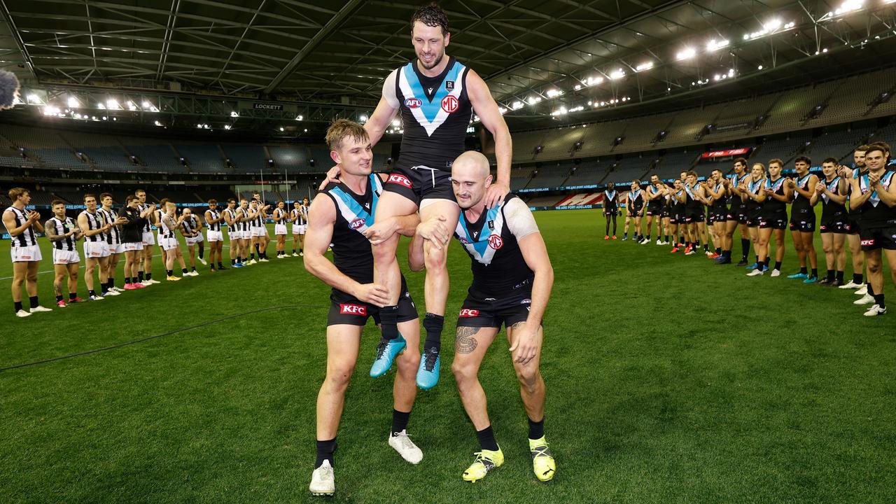 Travis Boak of the Power is chaired from the field after his 300th match by teammates Ollie Wines and Sam Powell-Pepper. Picture: Michael Willson