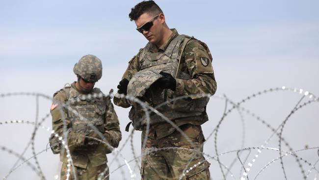 Soldiers string razor wire near the port of entry at the US-Mexico border. Picture: AFP.