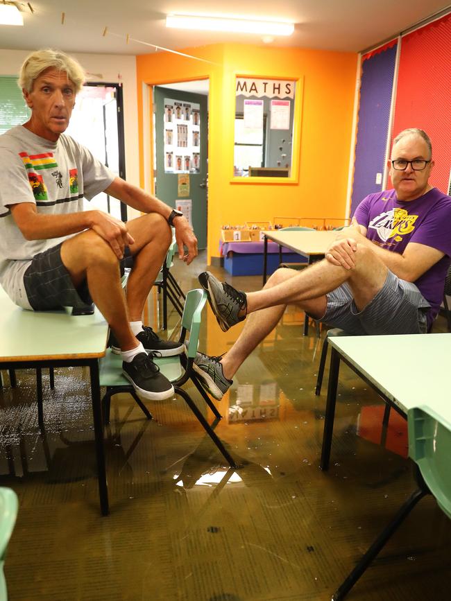 Princiapl Dr Adrian Waters and teacher Matthew Keys in a flooded Bellbrae Primary School prep room. Picture: Alison Wynd