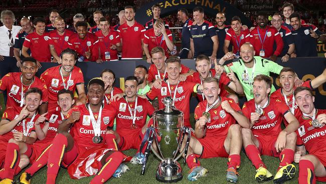 Adelaide United players celebrate with the FFA Cup. Picture: Sarah Reed