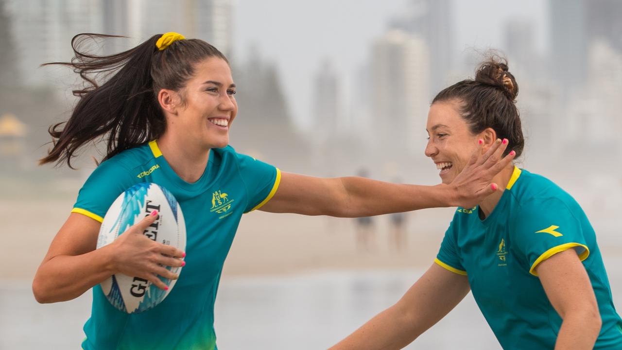 Charlotte Caslick and Emilee Cherry of the Australian Women's Sevens team having a run on a Gold Coast beach before the tournament starts this weekend. Photo: RUGBY.com.au/Stuart Walmsley