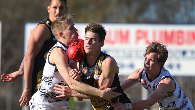 Helyar (South Adelaide) lays a tackle on Myponga/Sellicks’ Elliot Chalmers (Glenelg). Dean Martin