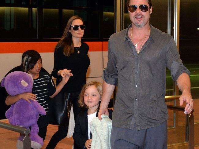 Brad Pitt, pictured with two of his children, is said to be desperate to see them. Picture: AFP/Yoshikazu TSUNO