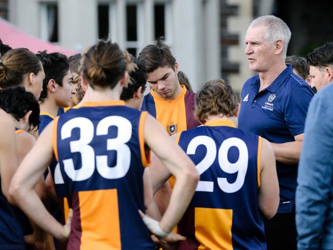 Mark Mickan talking to St Michael's players at the quarter-time huddle in Adelaide, Saturday, May 5, 2018.  (AAP Image/Morgan Sette)