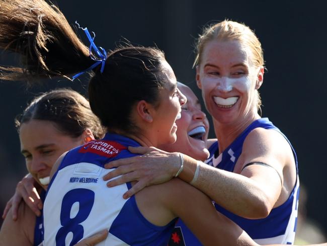 BRISBANE, AUSTRALIA - SEPTEMBER 01: Vikki Wall, Taylah Gatt and Kate Shierlaw of the Kangaroos celebrate a goal during the round one AFLW match between Brisbane Lions and North Melbourne Kangaroos at Brighton Homes Arena, on September 01, 2024, in Brisbane, Australia. (Photo by Mackenzie Sweetnam/Getty Images)