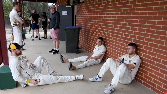 Players wait out the rain on Saturday. Picture: Andy Brownbill