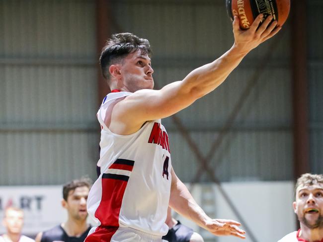 Norwood Flames player Matthew Lycett attempts a lay-up. Picture: Rod Patterson