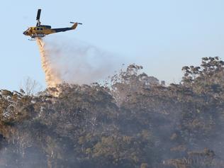 A helicopter waterbombs a bushfire at Cedar Creek. Pic: Glenn Hampson.