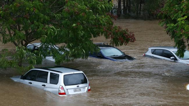 Cars submerged at the rear of the Robina Hospital. Picture: NIGEL HALLETT