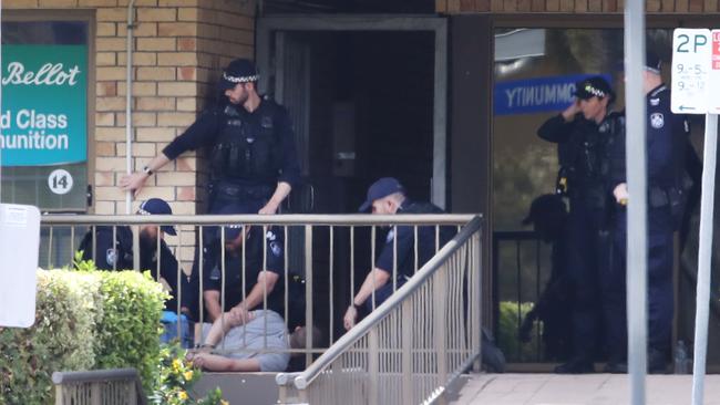 The man is arrested by police officers at the end of the siege. Picture: Glenn Hampson.