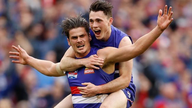 Tom Boyd celebrates with Toby McLean after kicking a goal in the 2016 Grand Final.