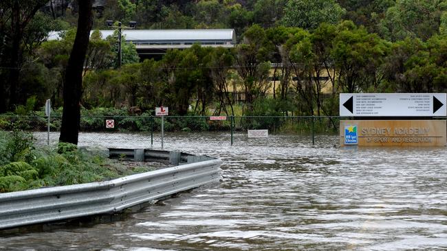 Flooding along Wakehurst Parkway at the entrance to the Sydney Academy of Sport at Narrabeen. Picture: News Corp