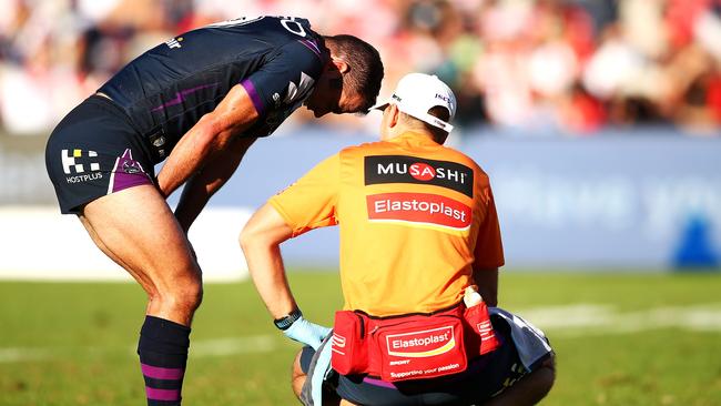 Storm skipper Cameron Smith receives attention from the trainer.