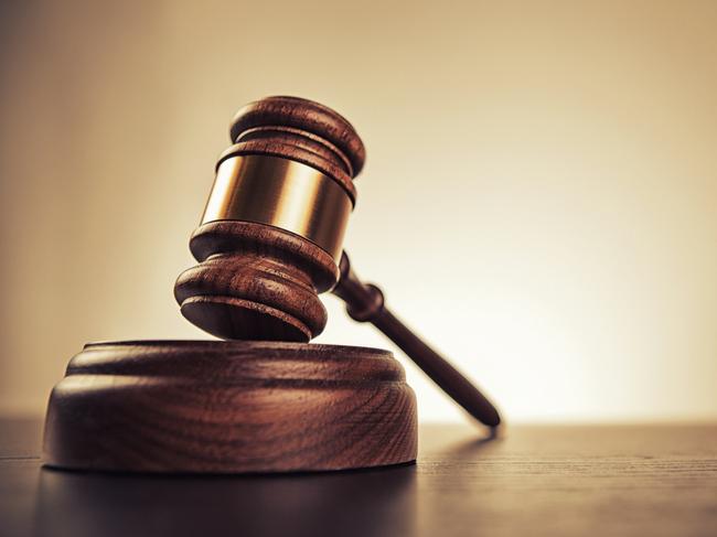 Gavel on desk. Isolated with good copy space. Dramatic lighting.