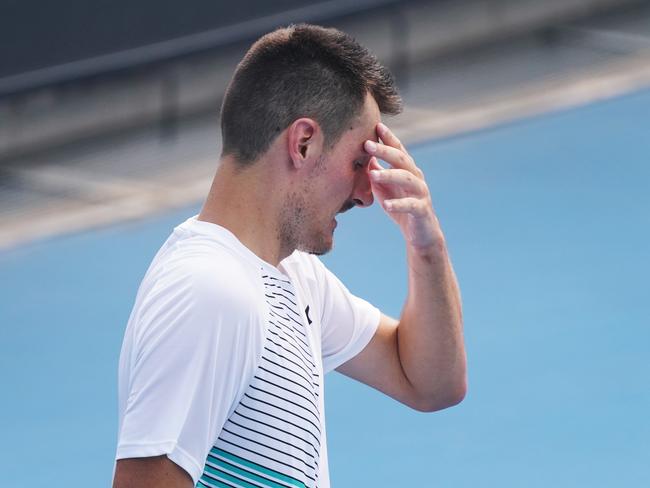 Bernard Tomic of Australia looks fatigued in his qualifying match against Denis Kudla of the USA during an Australian Open practise session at Melbourne Park in Melbourne, Tuesday, January 14, 2020. (AAP Image/Michael Dodge) NO ARCHIVING, EDITORIAL USE ONLY