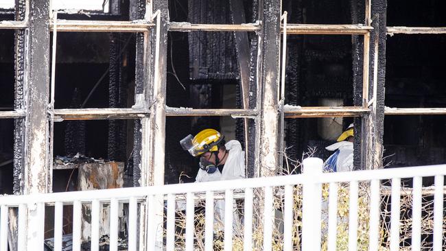 Police and fire investigators at the site of the fire at Cosgrove High School. Picture: RICHARD JUPE