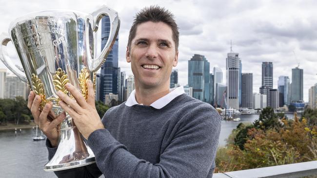 Former Brisbane Lions premiership player, Simon Black, holding the AFL Premiership cup, during its AFL Premiership Cup tour.