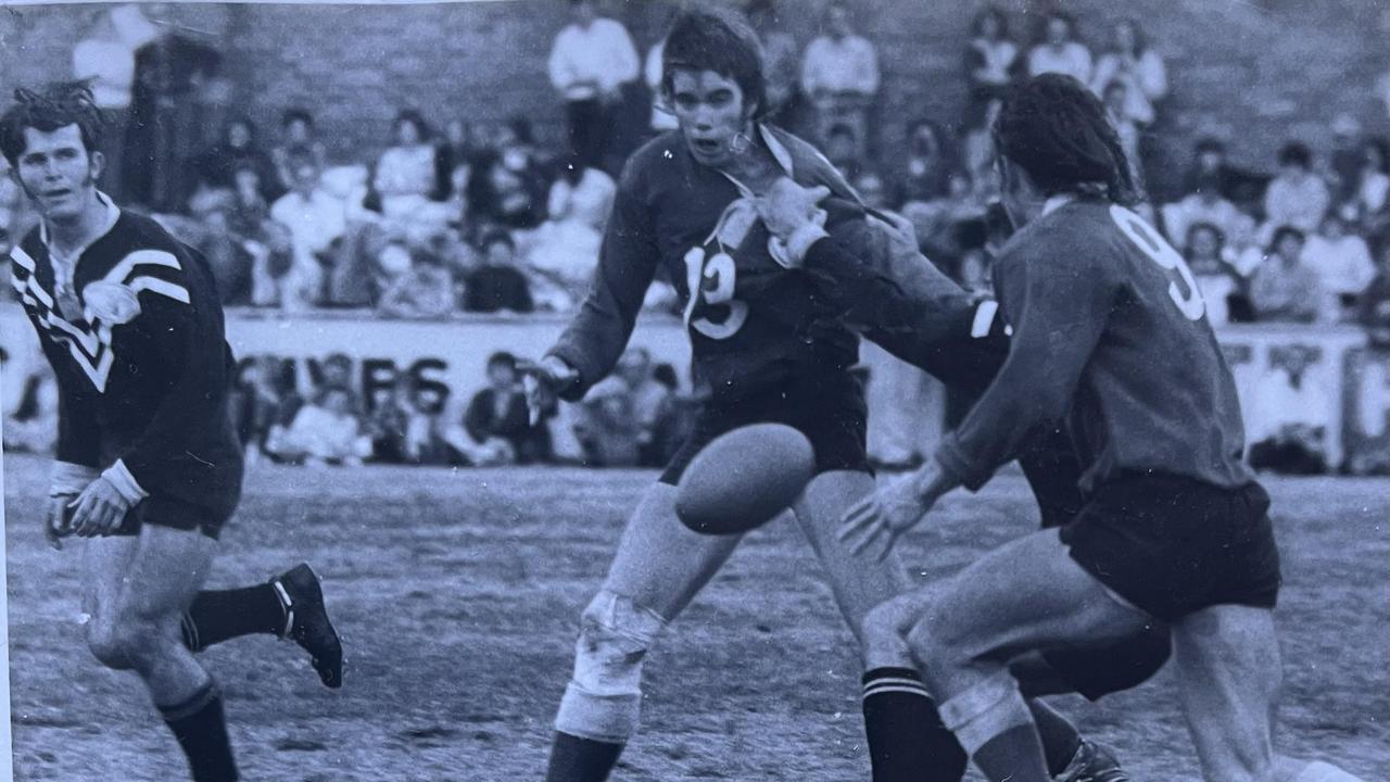 Newtown Lions' Gary (Barney) Meara passes to Graeme Wockner (No. 9) as Oakey Bears' centre Nev Tate (left) looks to cover defend in the 1973 Toowoomba Rugby League grand final.