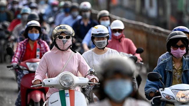 Commuters wearing face masks in Hanoi, Vietnam. Picture: AFP