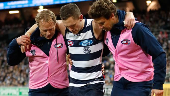 Joel Selwood is helped from the ground after hurting his ankle. Picture: Getty Images