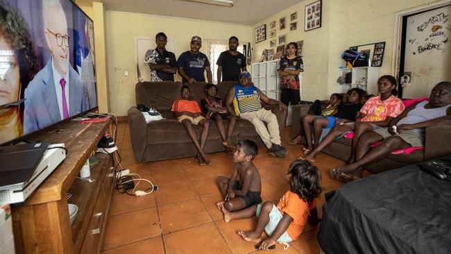 Phillip Goodman and his extended family watch the voice announcement at their home in 15 Mile Creek Camp. Picture: Liam Mendes