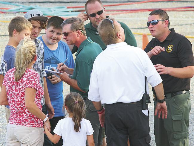 Fair officials, including Fair Board President Bobby Holt, centre, talk to witnesses. Picture: O.J. Early/The Greeneville Sun via AP