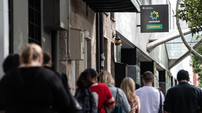 People queue for access to a Centrelink Service Centre in Sydney. Increased migration will add to the number of people out of work. Picture: AAP Image/James Gourley