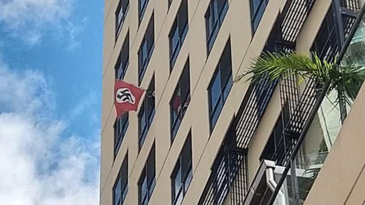 The flag flying out the window in Margaret Street on Saturday. Queensland Police arrived to removed the flag.