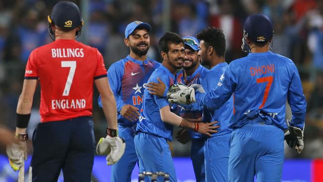 India's Yuzvendra Chahal, third left, celebrates one of his six wickets with teammates.