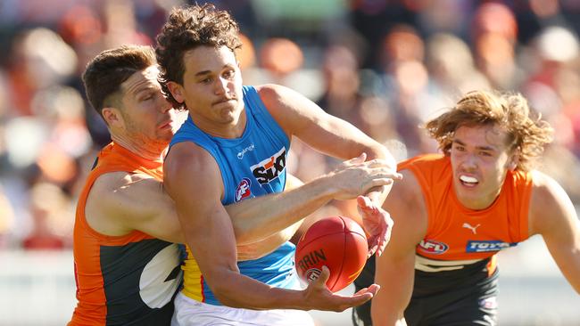 Toby Green lays a tackle on Wil Powell. Picture: Mark Nolan/AFL Photos/via Getty Images