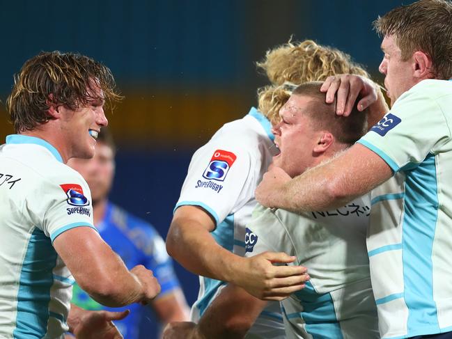 Tom Robertson of the NSW Waratahs (second right) celebrates after scoring a try.