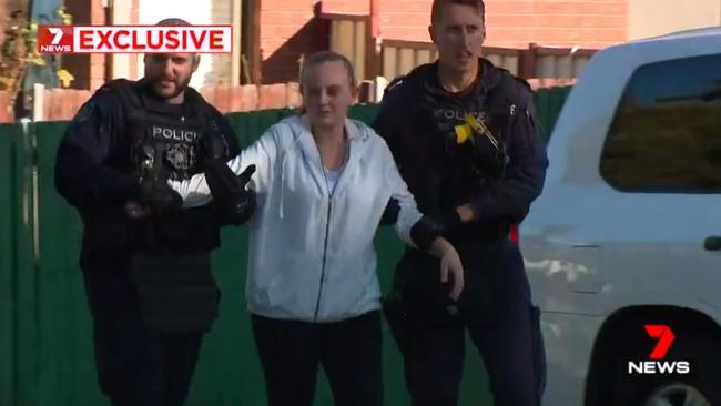 A woman wanted on an arrest warrant was also taken into custody. Picture: 7News