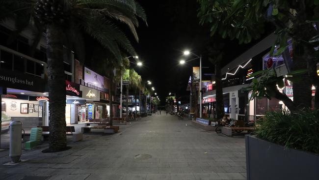 Hardly a soul in sight at the corner of Cavill Ave and Surfers Paradise Boulevard at about 8pm. Picture: Glenn Hampson.