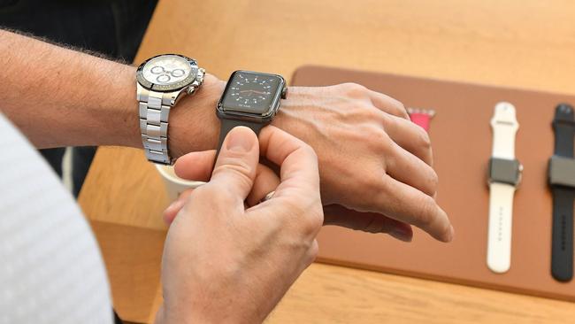 A customer tries on an Apple Watch at an Apple store in San Francisco. Picture: AFP PHOTO / Josh Edelson