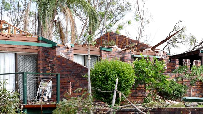 The roof is torn off a home at Tamworth Drive, as Helensvale was smashed by a ferocious storm in Christmas night leaving a trail of destruction and 1 woman losing het life. Pics Adam Head