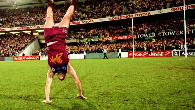 Footballer Jason Akermanis doing handstand. AFL football - Brisbane Lions vs Western Bulldogs match at the Gabba 11 Sep 1999. a/ct