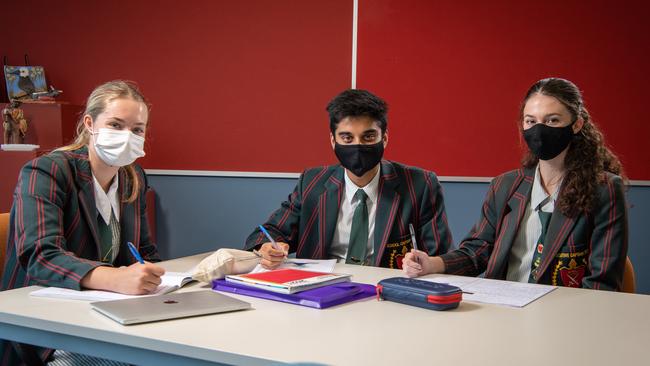 St Pauls Anglican School students Kadey Bretherton, Sameel Deoji and Gabby Munt on the first day of wearing masks to school. PICTURE: Brad Fleet