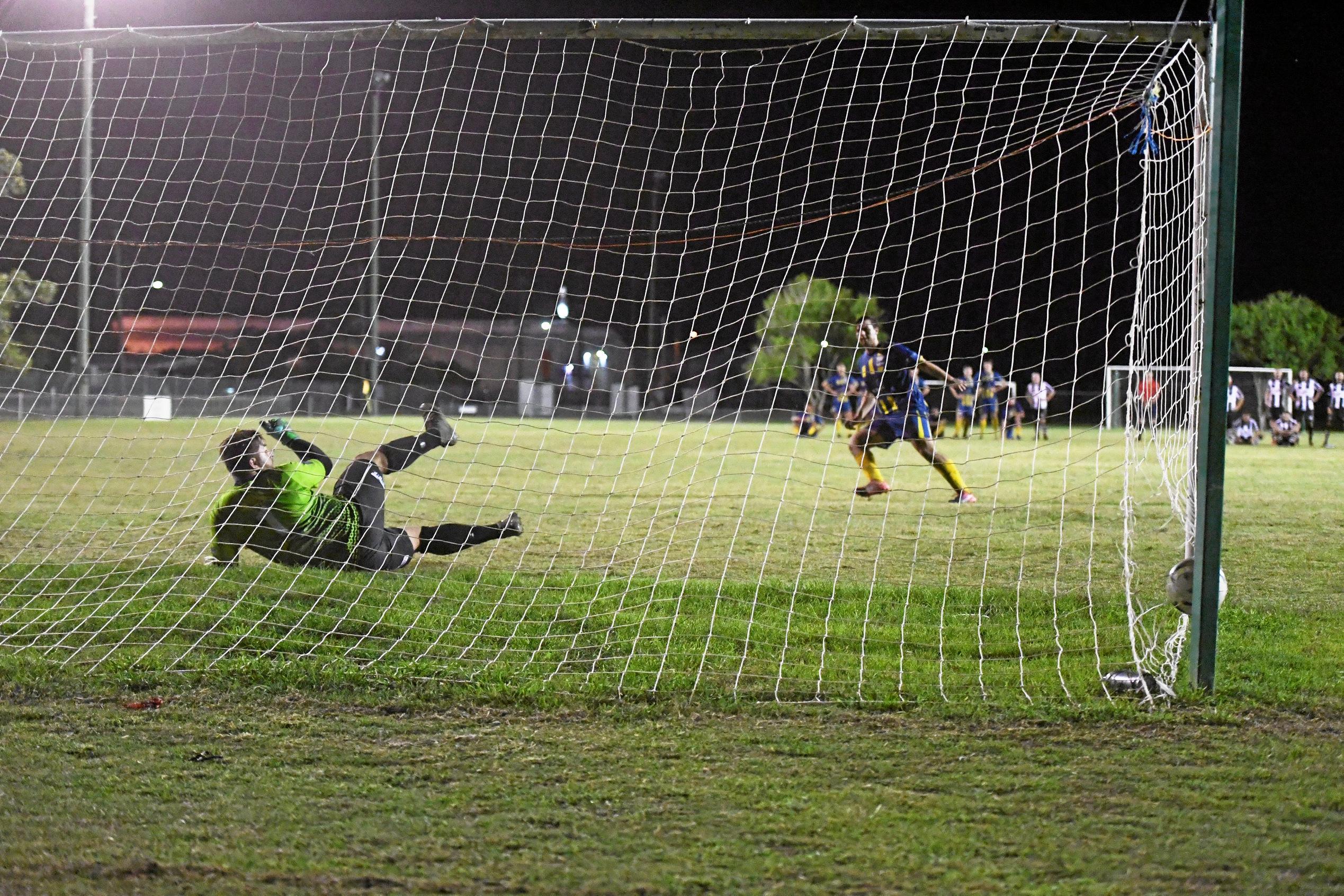 The Waves' Callum Hillier scores during the penalty shootout against Bingera. Picture: Shane Jones