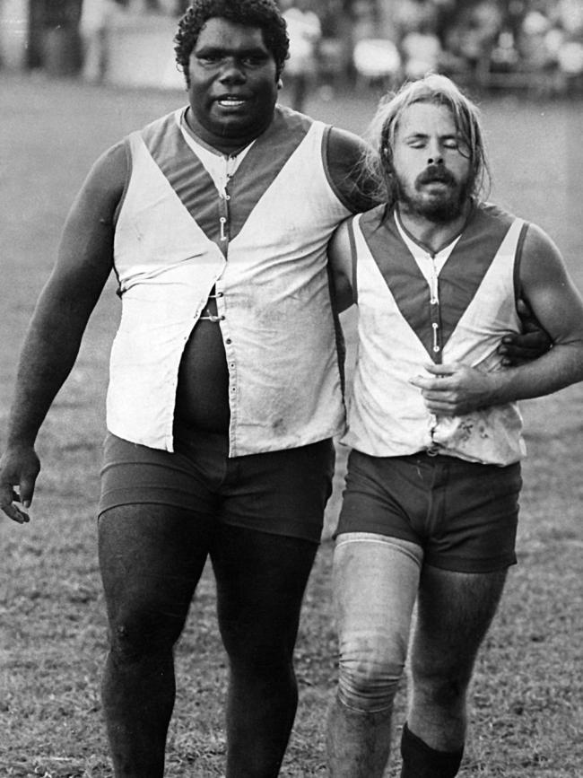 Charles Tipungwuti and Pumurali teammate Andy Mullins leave the ground after losing the Tiwi Islands Grand Final in 1980.